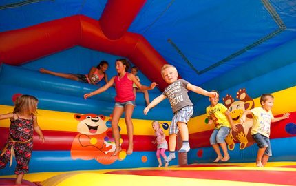 Spelende kinderen op een springkussen van Jb Inflatable